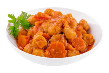 tiftels in carrot sauce in a bowl
