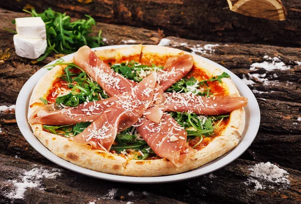 delicious Italian pizza with prosciutto and arugula