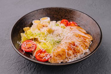 Caesar salad with lettuce, chicken, avocado and croutons