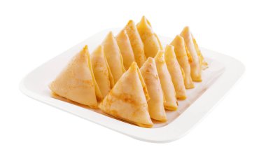 triangular pancakes with meat on plate