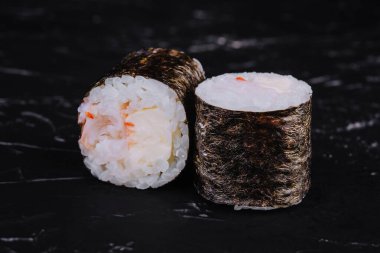 Sushi rolls with shrimp on black