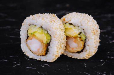 Sushi rolls with shrimp, avocado and sesame