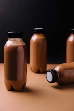 chocolate smoothies milkshake in bottles on brown background