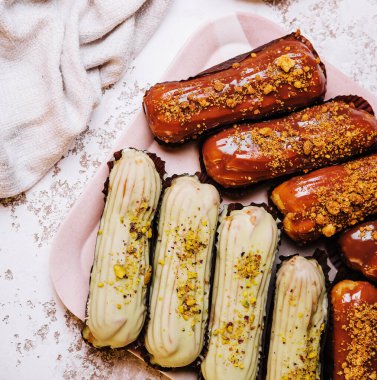 traditional french eclairs with chocolate and vanilla cream and cup of espresso