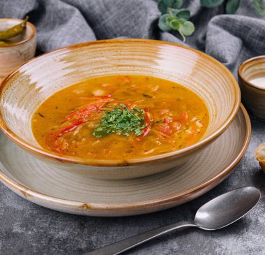 Traditional chicken noodle soup in a brown bowl