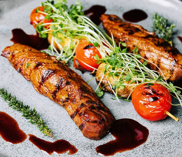 Stock image Tasty baked pork tenderloin with grilled vegetables