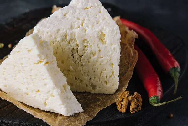 Stock image soft sheep cheese on black wooden tray