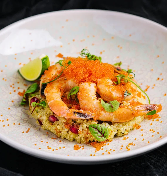 stock image Couscous with vegetables and shrimp under red caviar