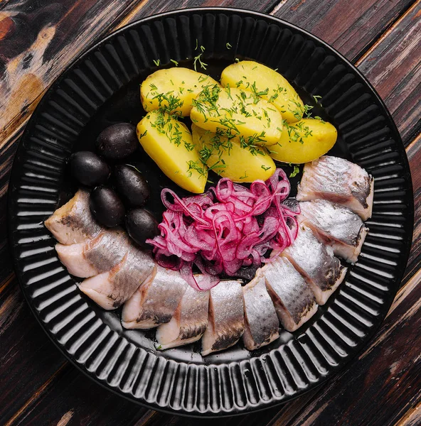 stock image tasty marinated herring with potatoes and onions