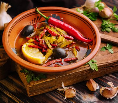 Meat Solyanka soup on a wooden board