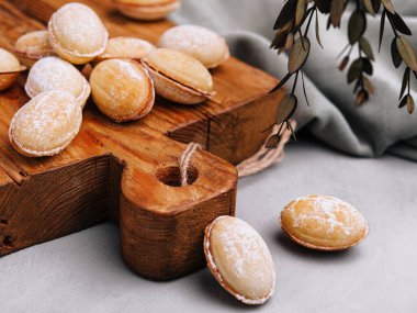 Walnut shaped cookies with caramel on wood