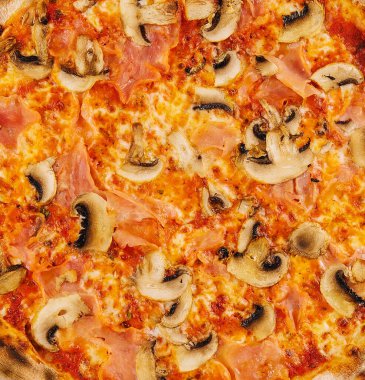 Thin crust italian pizza with tomato sauce, cheese, ham and mushrooms
