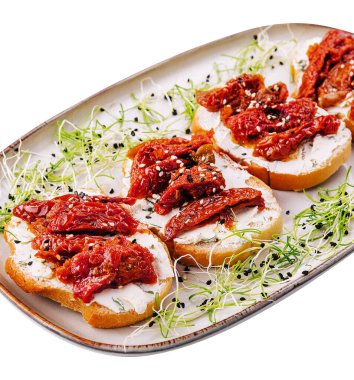 Bruschettas on plate on white background