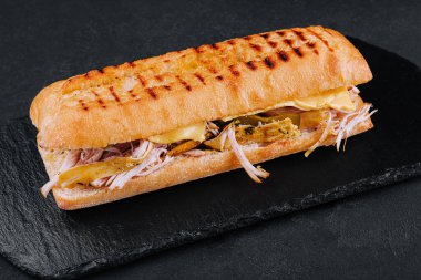Big sandwich with chicken on stone board