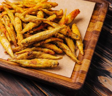 Dried small salted fish heap on crumpled paper