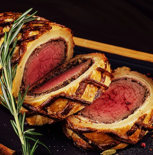 stock image Beef tenderloin rolls stuffed on wooden board