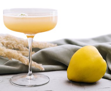 quince cocktail in a glass isolated