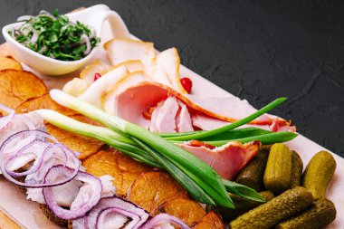 Rustic appetizer for vodka on wooden board