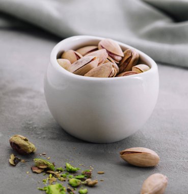 Cup of heart latte art and pistachios