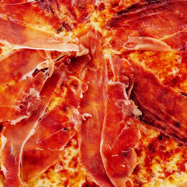 Pizza with prosciutto, cheese, tomato sauce