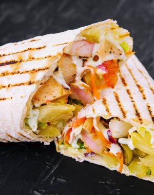 Delicious chicken shawarma on black stone