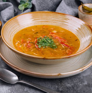 Traditional chicken noodle soup in a brown bowl