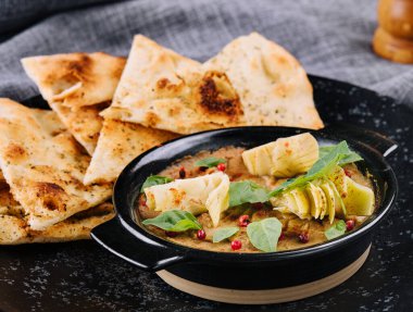 Italian focaccia bread on black plate