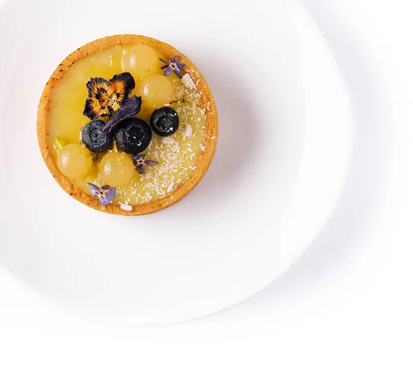 Lemon curd mini tarts on white plate