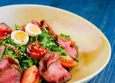 Veal carpaccio with arugula and eggs