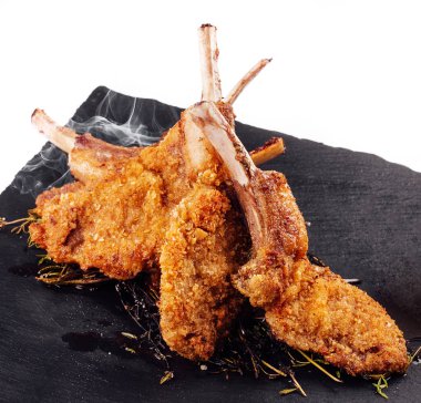 Roasted pork ribs, garnished with onion chips and mashed potatoes