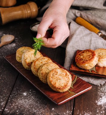 Vegetable zucchini pancakes with cheese, dill and parsley on a plate