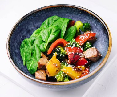 meat with grilled vegetables in bowl