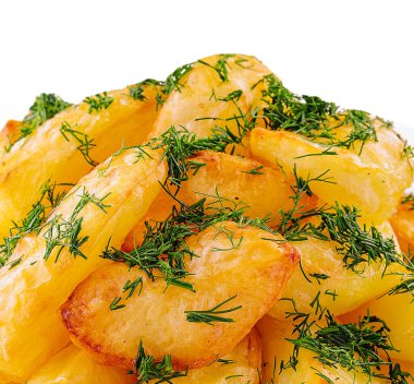 Fried potato slices with dill on plate
