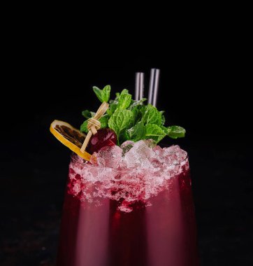 glass of red soft drink on black background