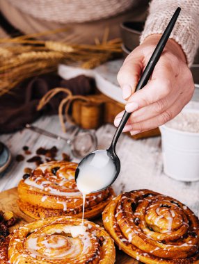 Homemade raisin roll pastry with vanilla icing