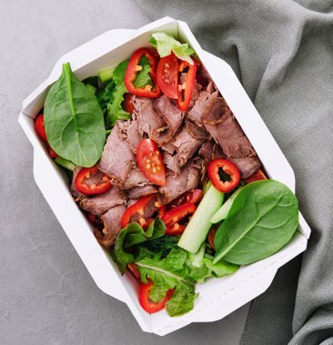 Beef steak salad with cherry tomatoes, cucumbers and basil