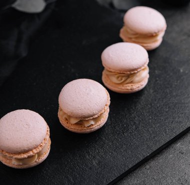 Delicate crumbly delightful pink macaroons close up