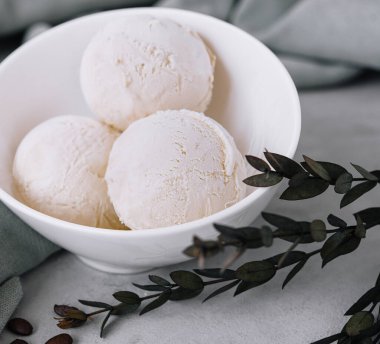 Vanilla ice cream balls on white bowl
