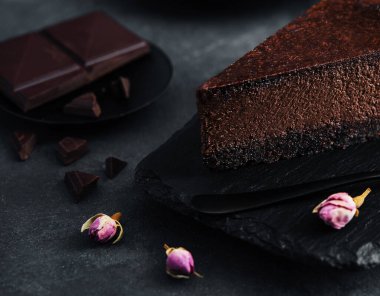 Chocolate cheesecake on black stone board
