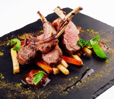 roasted lamb rack served with carrot, yellow curry and lamb sauce
