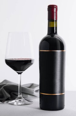 Red wine and wine bottle on stone