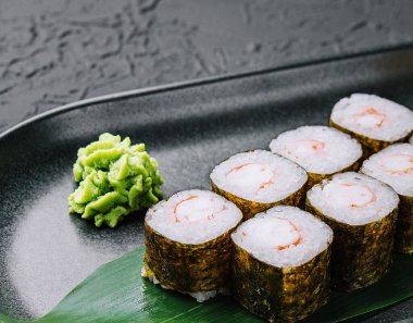 Traditional fresh japanese sushi maki on black stone plate