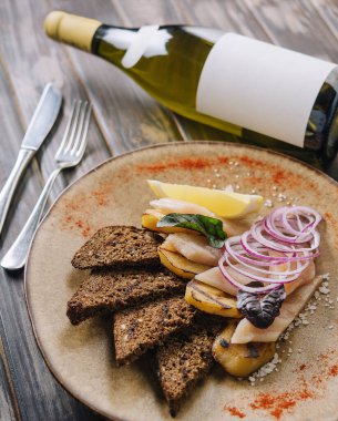 Herring with potatoes, onion with bread and wine