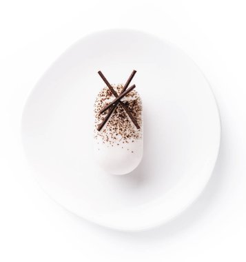 White mousse cake on white plate top view