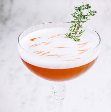Sweet and fresh cold alcoholic orange cocktail with foam