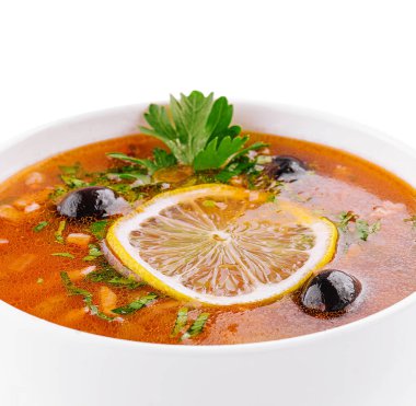 meat soup Solyanka in bowl on white