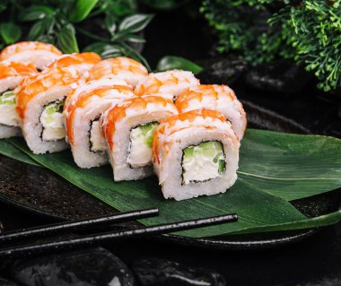 Fresh sushi rolls with shrimp on stone plate