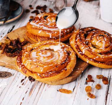 Homemade raisin roll pastry with vanilla icing