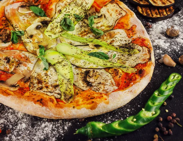 italian vegetarian pizza with zucchini, eggplant, mushrooms and tomato