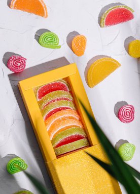 Multicolored marmalade in a box on top view